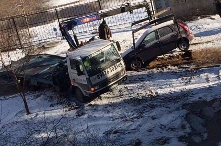 После работы коммунальщиков жители Волгограда вытаскивают свои авто на эвакуаторе